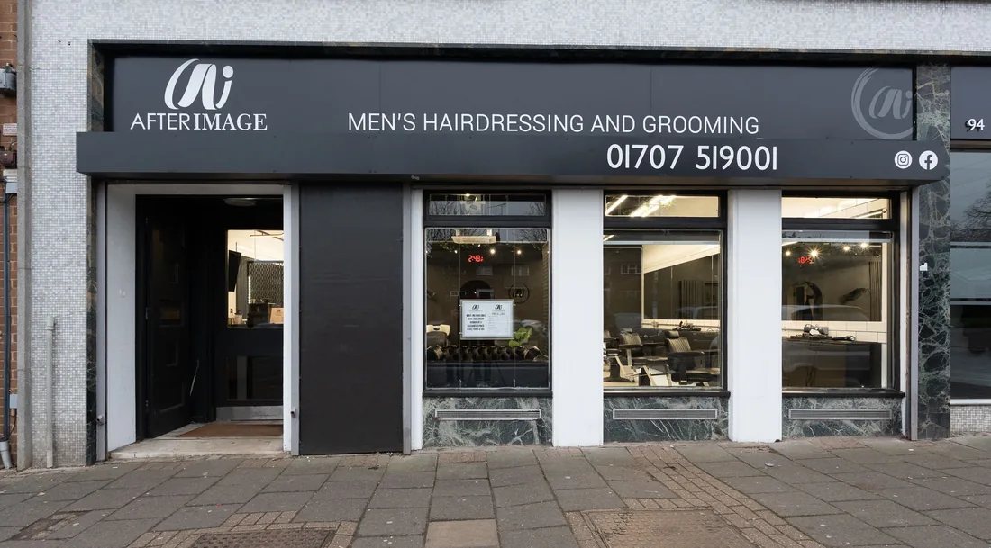 The front of After Image on 96 Haldens - a black shopfront with the sign above the window and the phone number above the door.